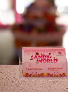 Carte de visite de la boutique, Candy World affichant le numéro de téléphone, l'adresse à Bruxelles et le compte Instagram